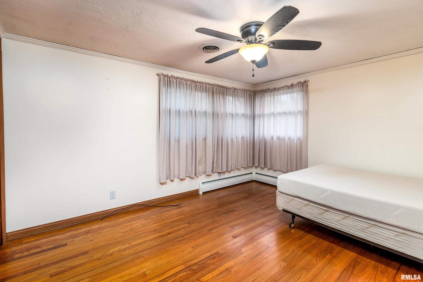 170 Melody Lane Murphysboro, IL 62966 - Photo 22 of 42 a spacious bedroom with a bed and a ceiling fan