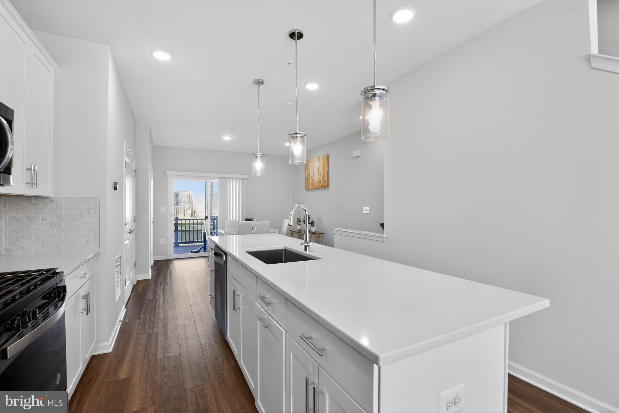299 Freshet Lane Laurel, MD 20724 - Photo 22 of 33 a kitchen with a sink stove and wooden floor