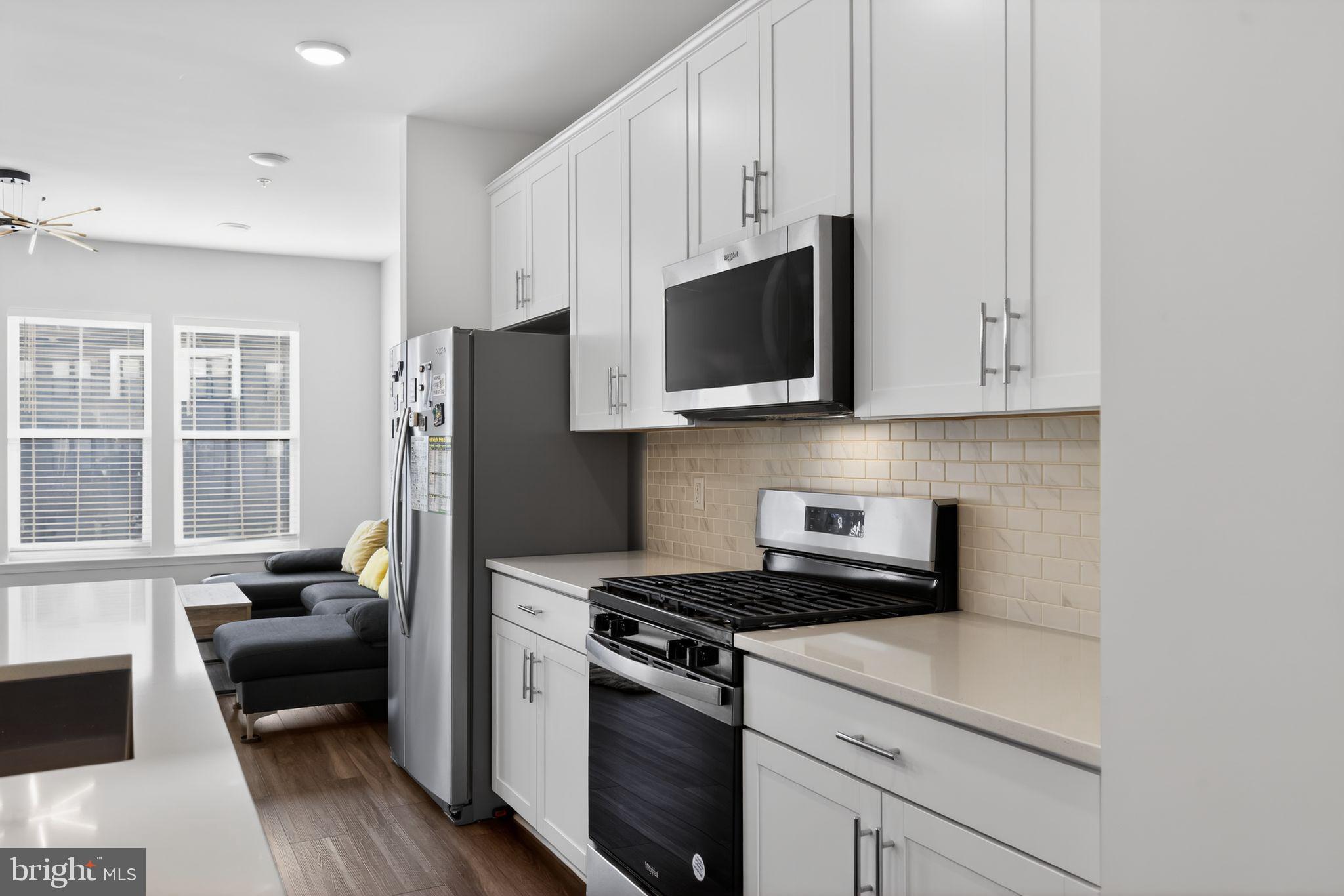 299 Freshet Lane Laurel, MD 20724 - Photo 23 of 33 a kitchen with stainless steel appliances granite countertop white cabinets a stove a sink and a refrigerator