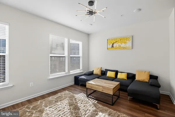 a living room with furniture and kitchen view