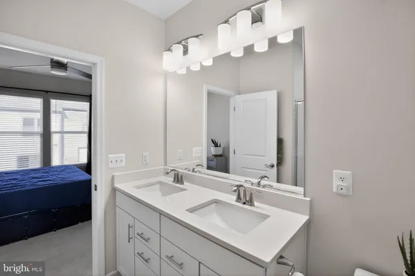 a en suite bathroom with a double vanity sink mirror and