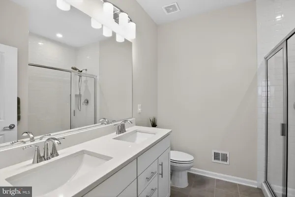 a bathroom with a double vanity sink and a mirror