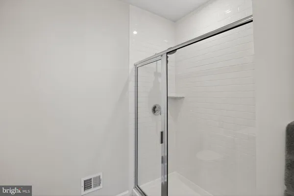 a bathroom with a glass shower door