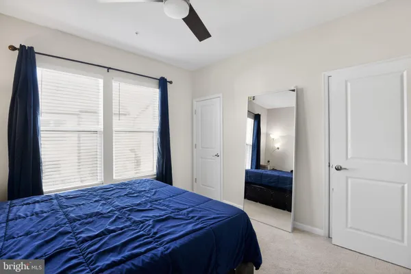 a bedroom with a bed and a large window