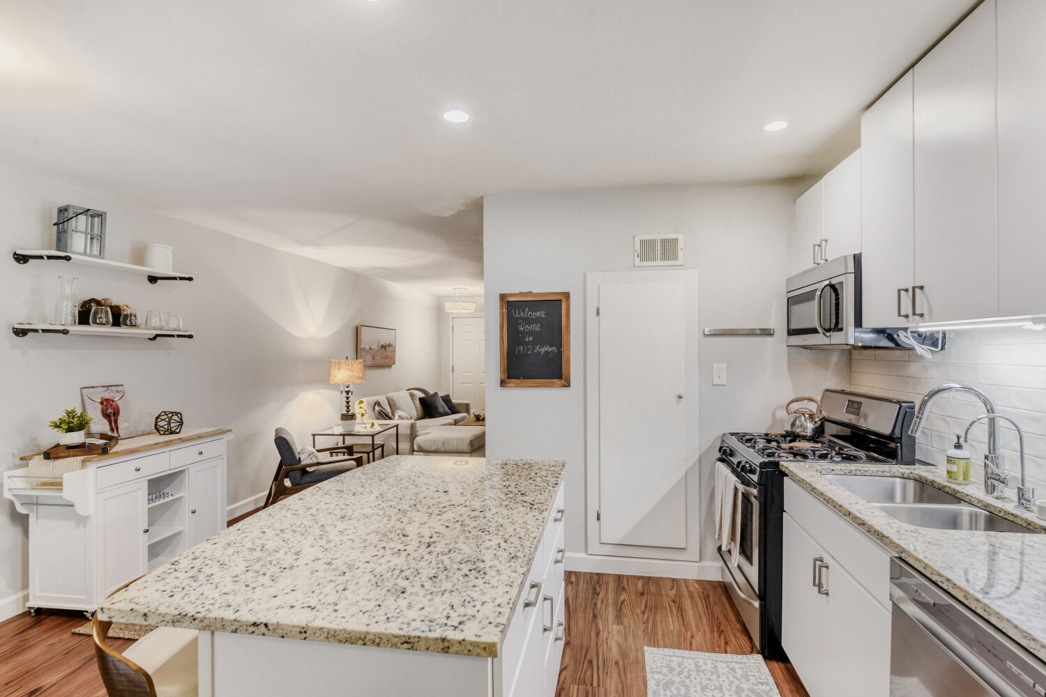 1912 Lightsey Road, Unit 6 Austin, TX 78704 - Photo 8 of 27 a kitchen with granite countertop a sink stove and cabinets