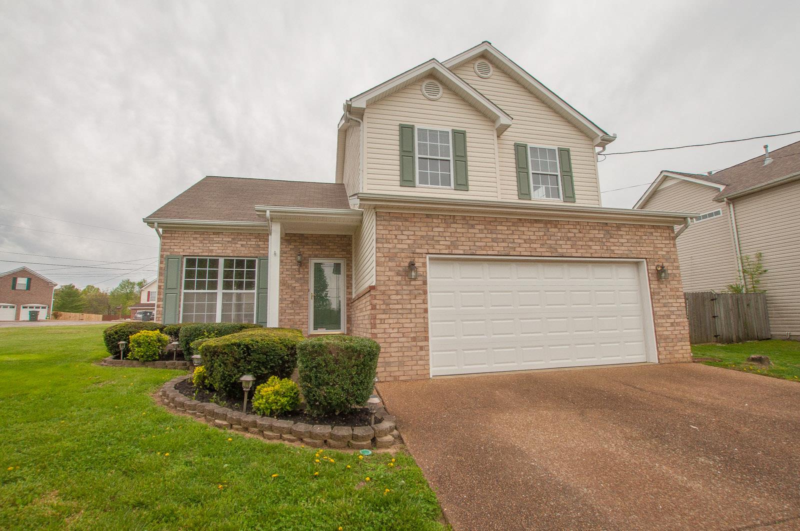 1556 Stone Hill Road Mount Juliet, TN 37122 - Photo 1 of 22 a front view of a house with a garden and plants