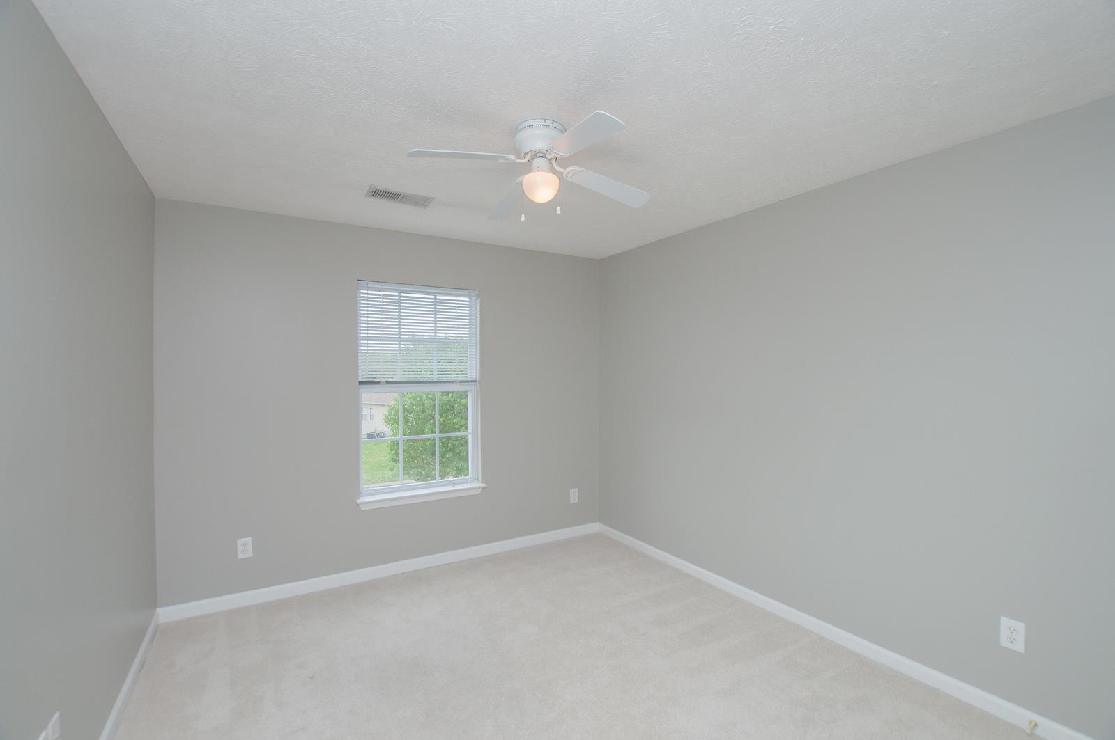 1556 Stone Hill Road Mount Juliet, TN 37122 - Photo 11 of 22 an empty room with a window and a fan