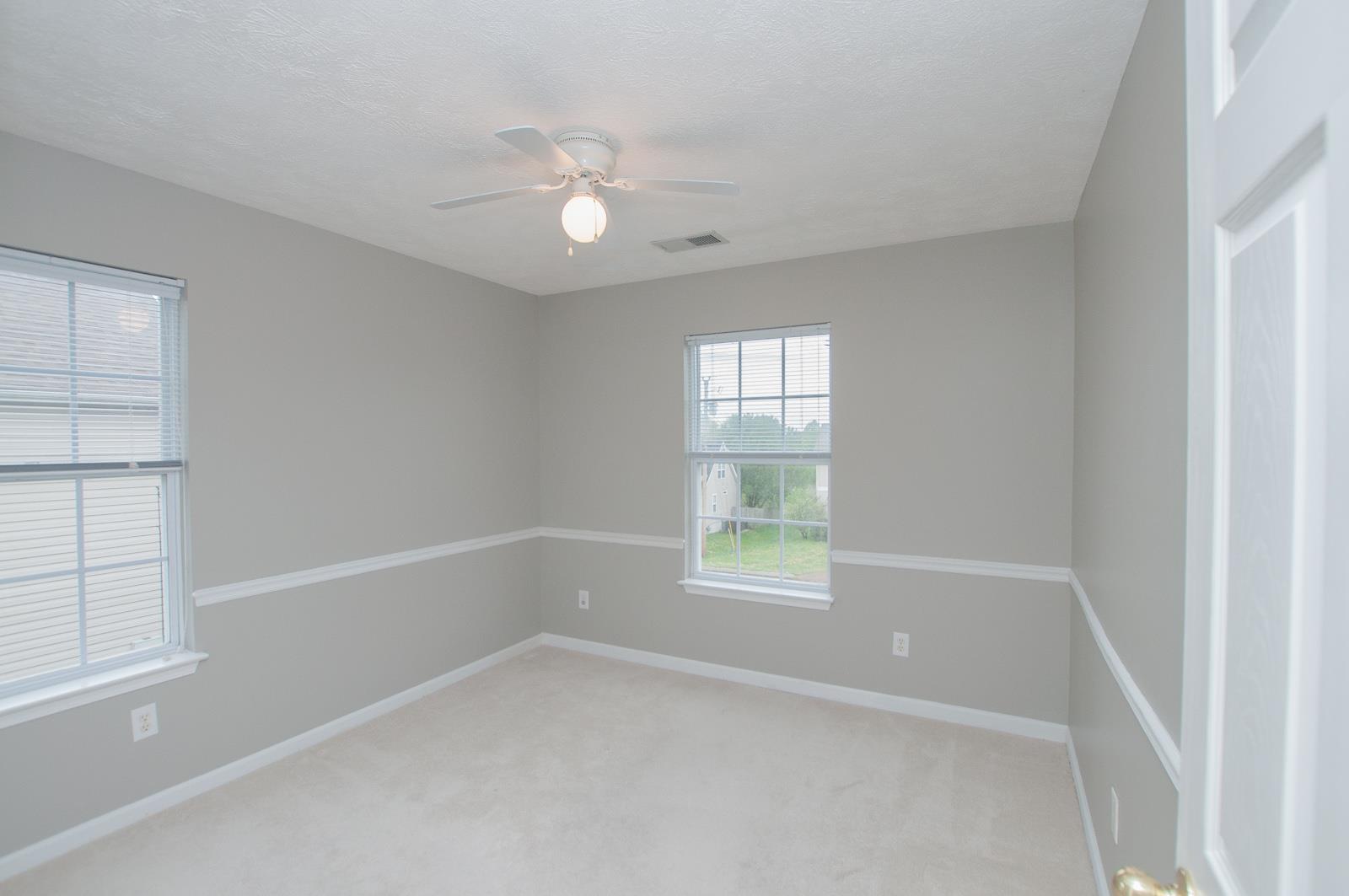 1556 Stone Hill Road Mount Juliet, TN 37122 - Photo 12 of 22 an empty room with windows and fan