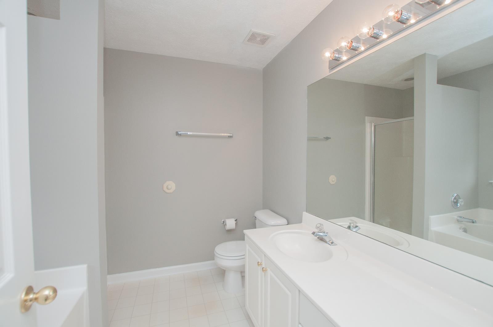 1556 Stone Hill Road Mount Juliet, TN 37122 - Photo 14 of 22 a en suite bathroom with a sink a toilet and a mirror