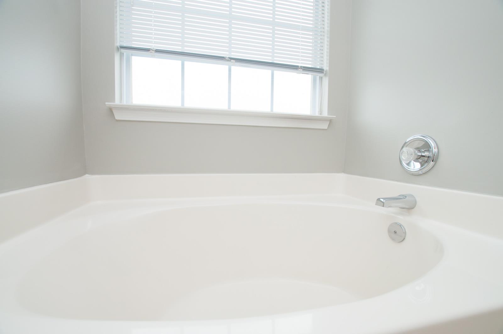 1556 Stone Hill Road Mount Juliet, TN 37122 - Photo 15 of 22 a bathroom with bathtub and window
