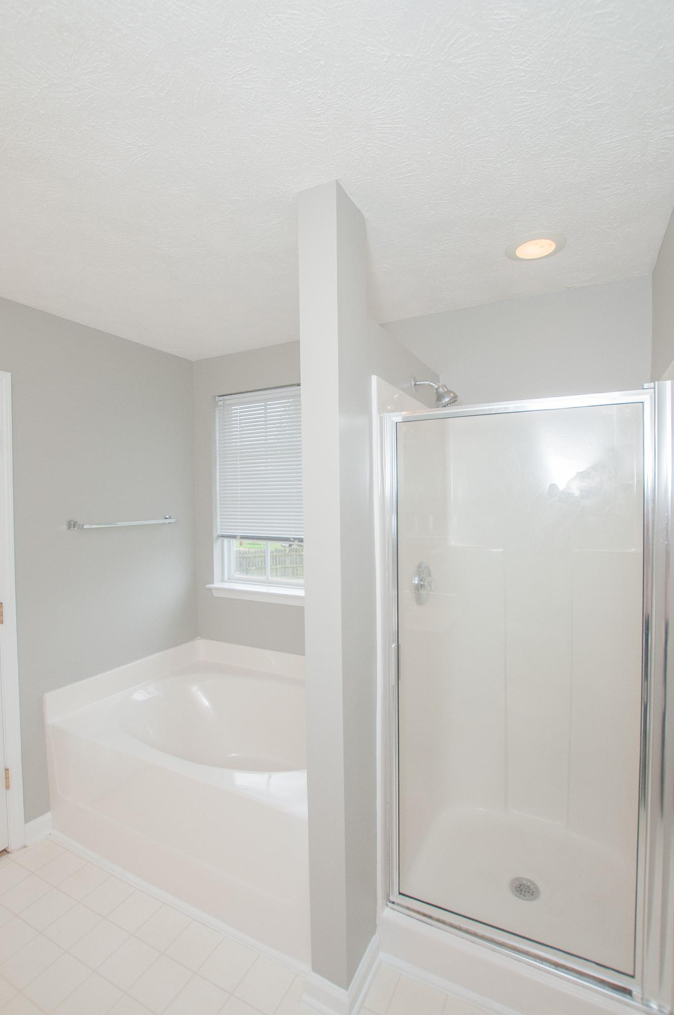 1556 Stone Hill Road Mount Juliet, TN 37122 - Photo 16 of 22 a bathroom with a bathtub and a shower