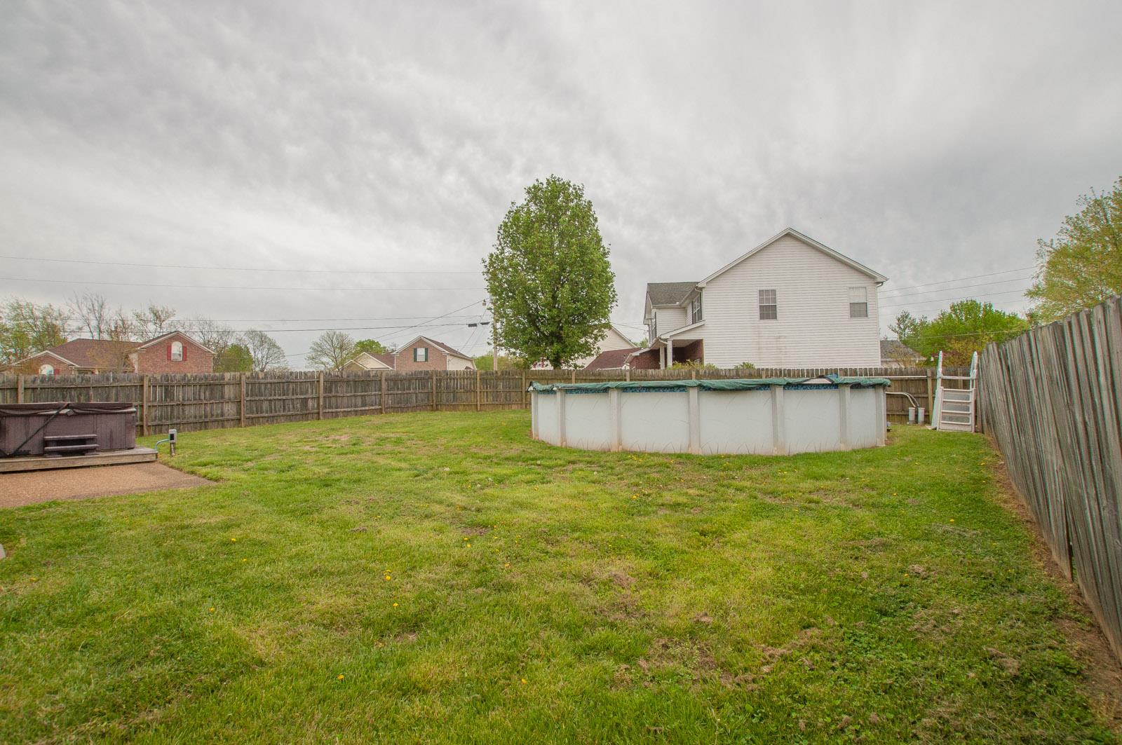 1556 Stone Hill Road Mount Juliet, TN 37122 - Photo 20 of 22 a view of a house with a yard and a large tree
