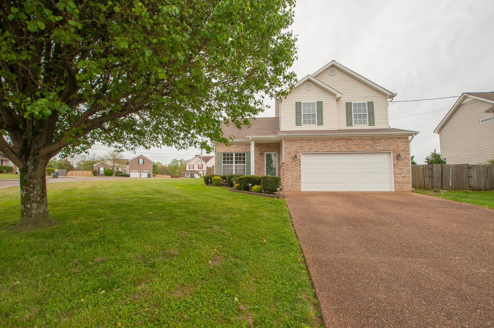 1556 Stone Hill Road Mount Juliet, TN 37122 - Photo 3 of 22 a front view of a house with a yard and garage