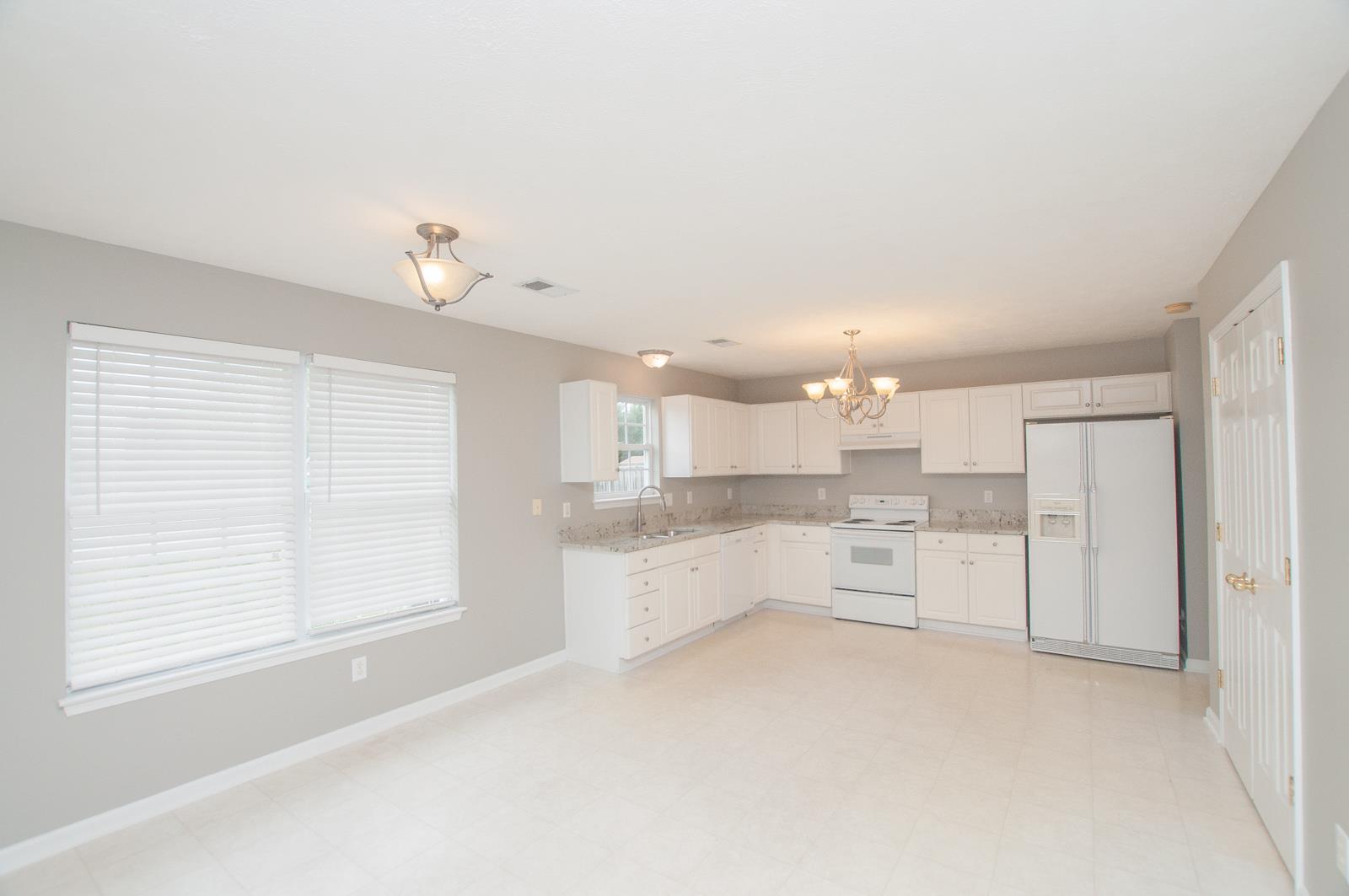 1556 Stone Hill Road Mount Juliet, TN 37122 - Photo 9 of 22 a large white kitchen with cabinets and a refrigerator