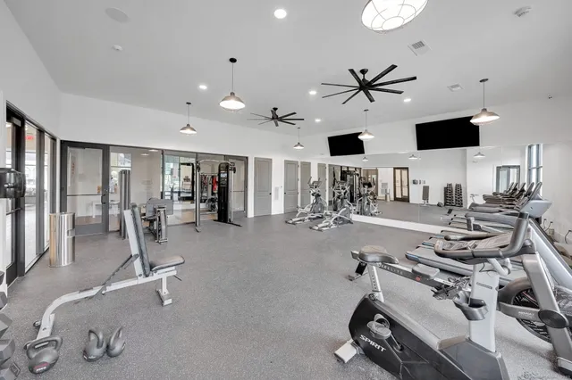 a room with gym equipment and a large window