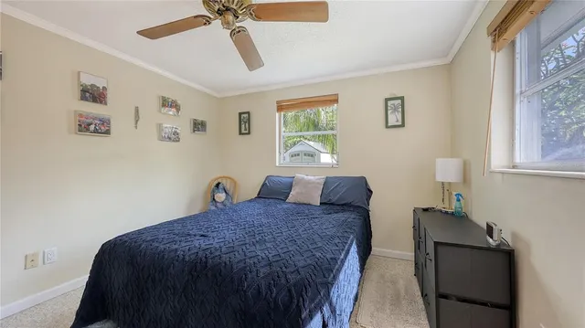 a spacious bedroom with a bed and a chandelier