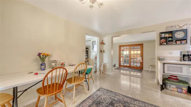 a dining room with furniture and wooden floor