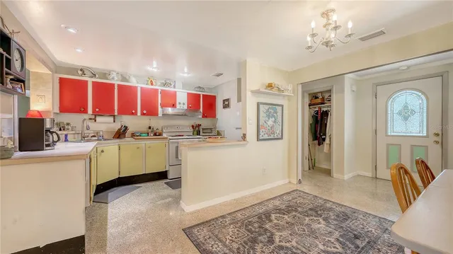 a kitchen with cabinets and window