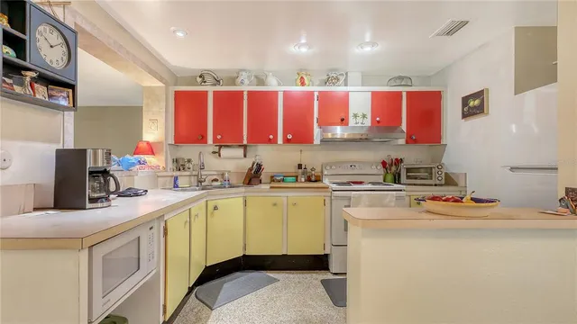 a kitchen with a sink window and cabinets