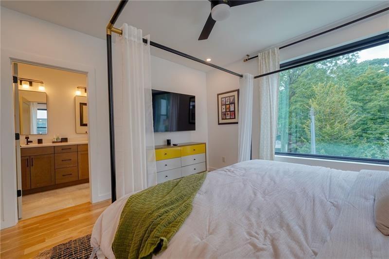 829 Barnett Street Northeast Atlanta, GA 30306 - Photo 19 of 41 a bedroom with a bed and a view of bathroom