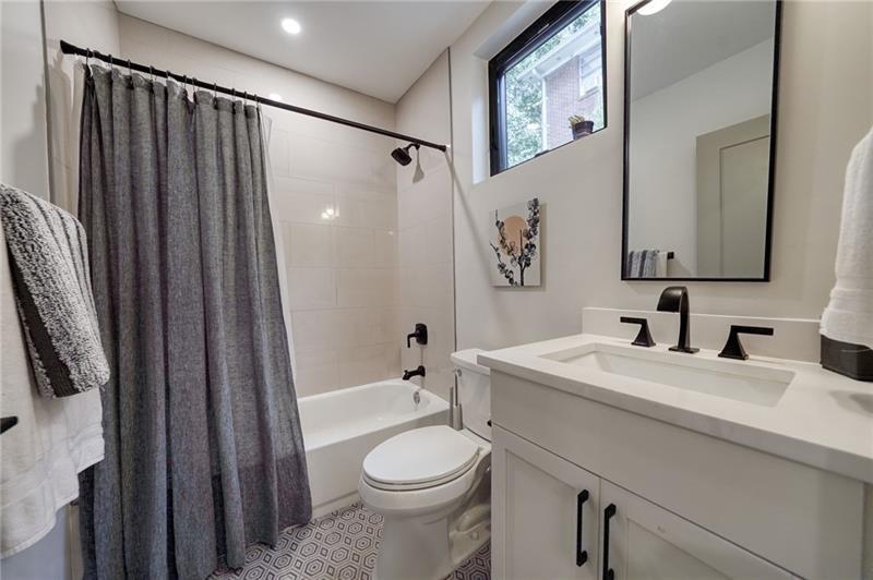 829 Barnett Street Northeast Atlanta, GA 30306 - Photo 33 of 41 a bathroom with a sink a toilet and shower