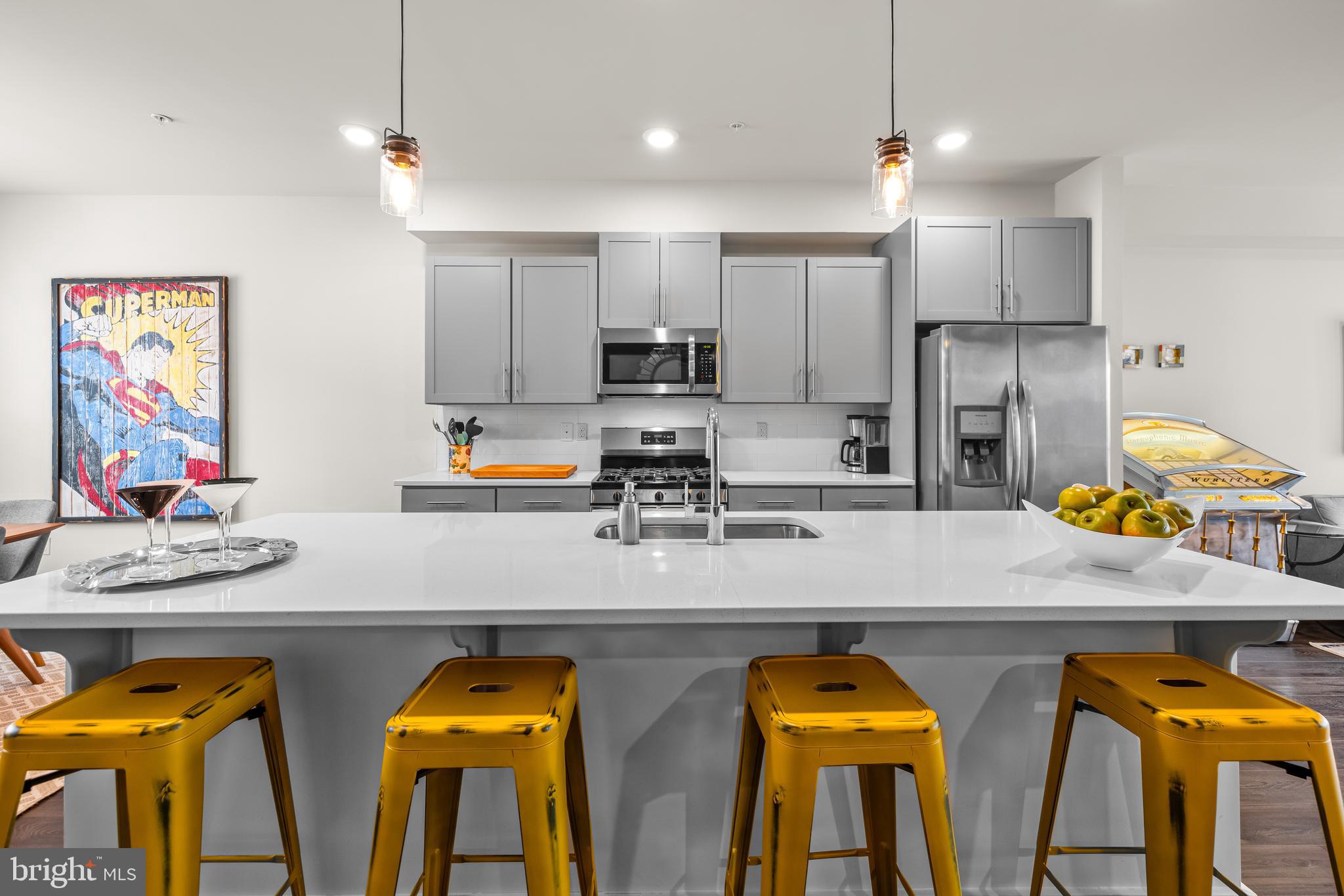 4307 La Plata Avenue Baltimore, MD 21211 - Photo 19 of 54 a kitchen with stainless steel appliances granite countertop a stove and white cabinets