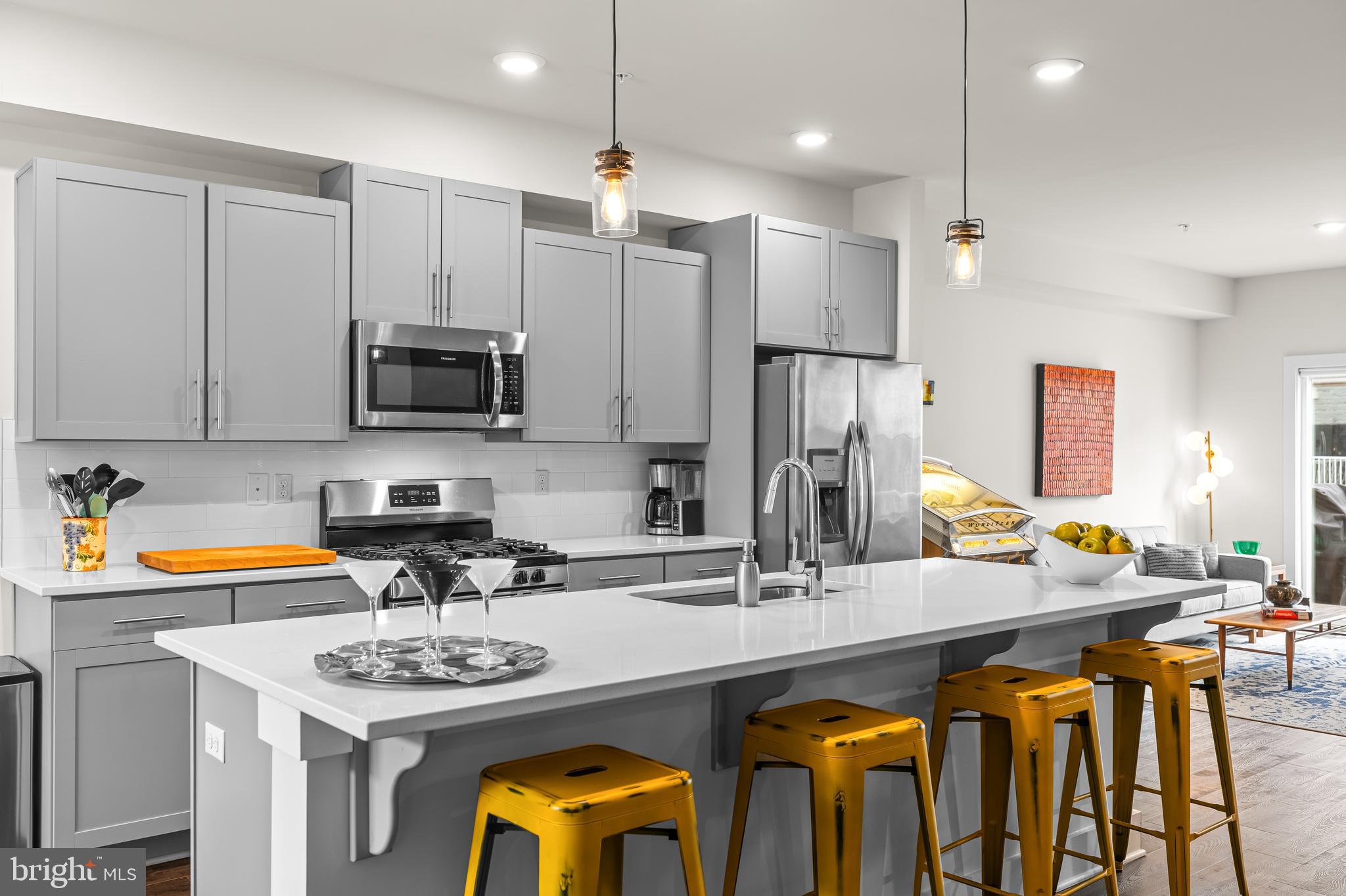 4307 La Plata Avenue Baltimore, MD 21211 - Photo 21 of 54 a kitchen with stainless steel appliances kitchen island granite countertop a sink and cabinets
