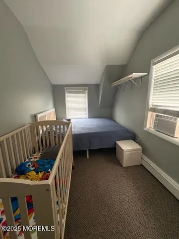 a view of a livingroom with wooden floor and a flat screen tv