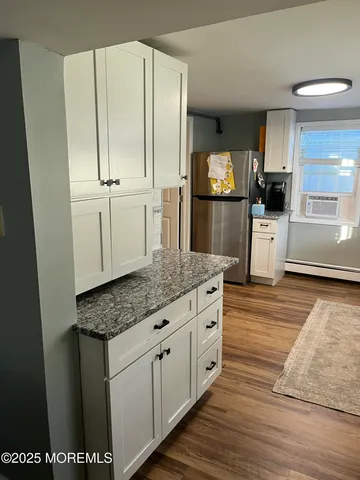 a view of a white house with a small space