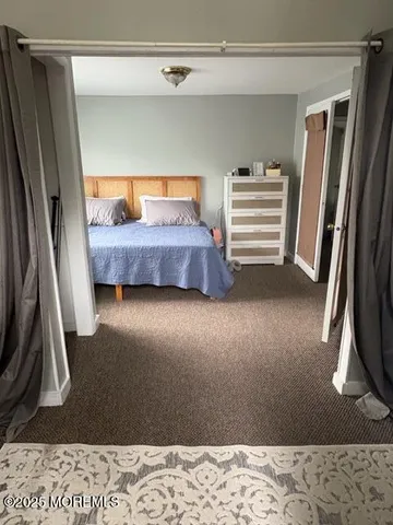 a bedroom with a bed next to a window