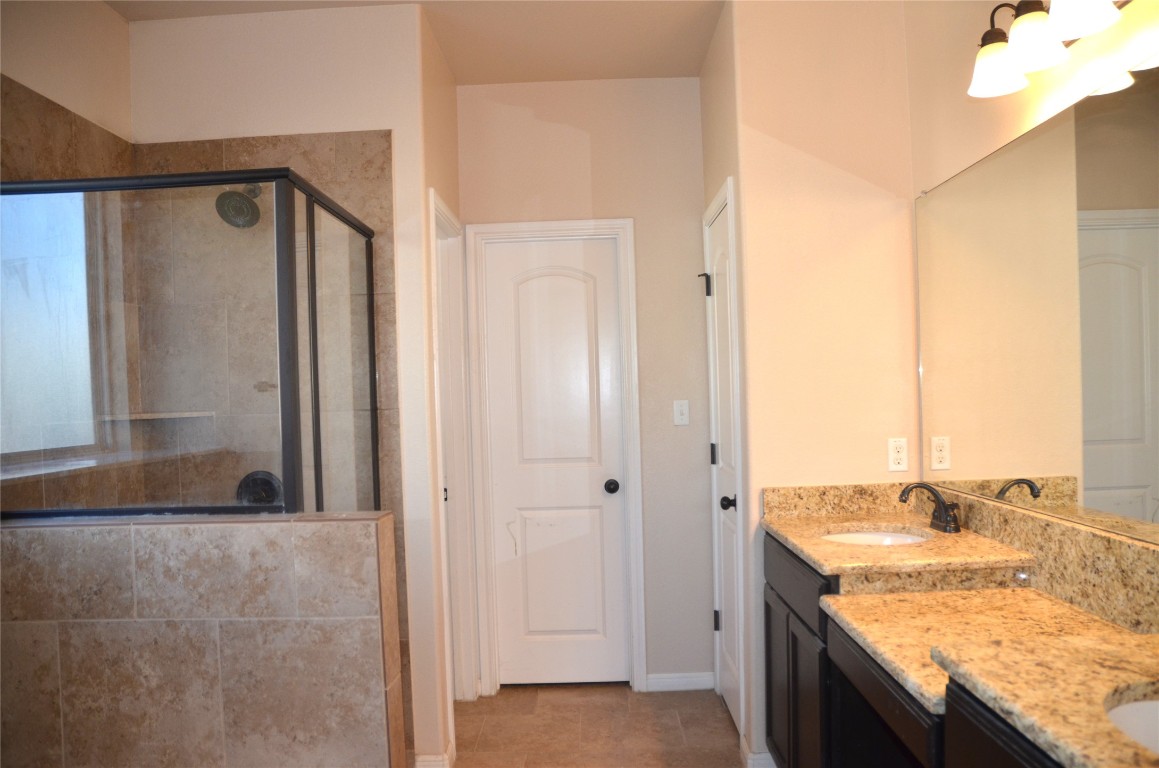 8528 Reggio Street Round Rock, TX 78665 - Photo 13 of 27 a bathroom with a granite countertop sink and a mirror