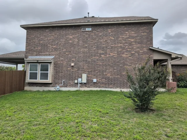 a front view of a house with a garden and yard