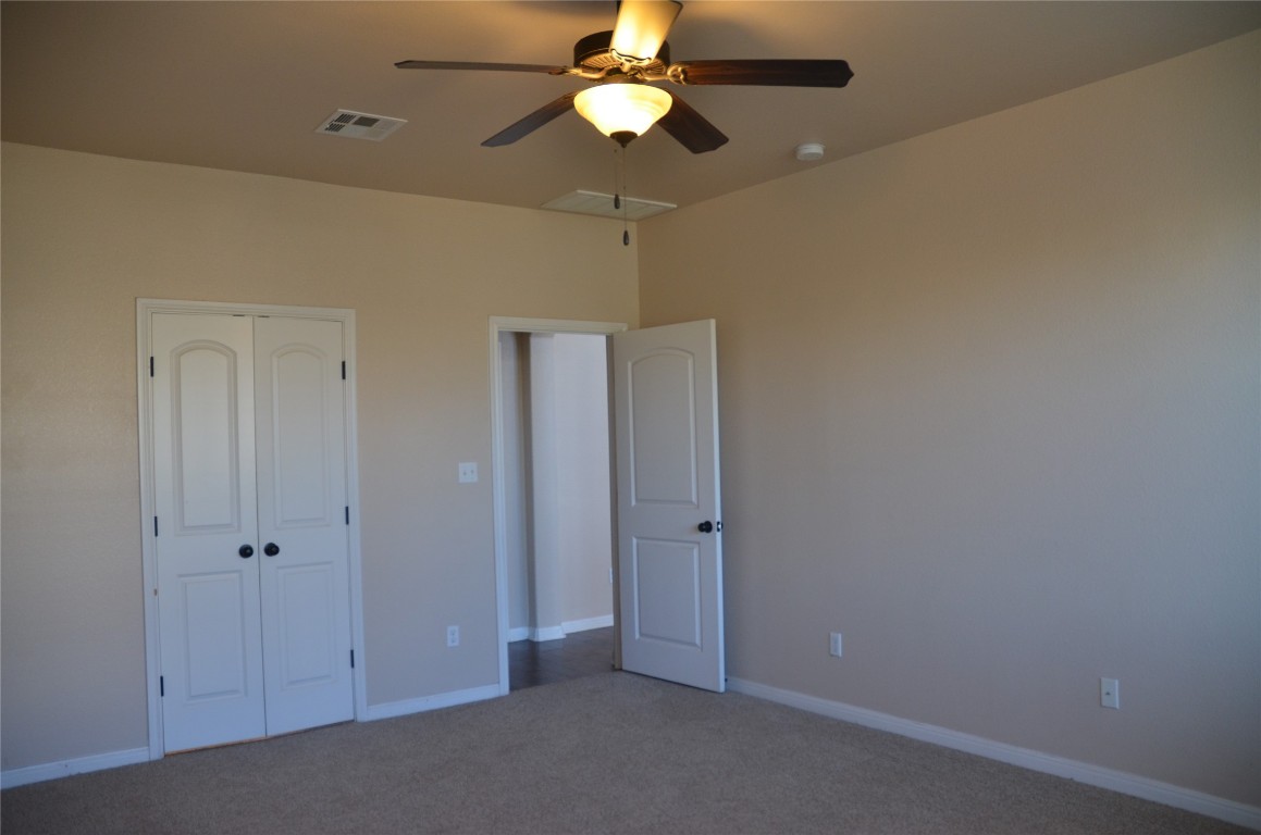 8528 Reggio Street Round Rock, TX 78665 - Photo 21 of 27 a view of an empty room and chandelier fan