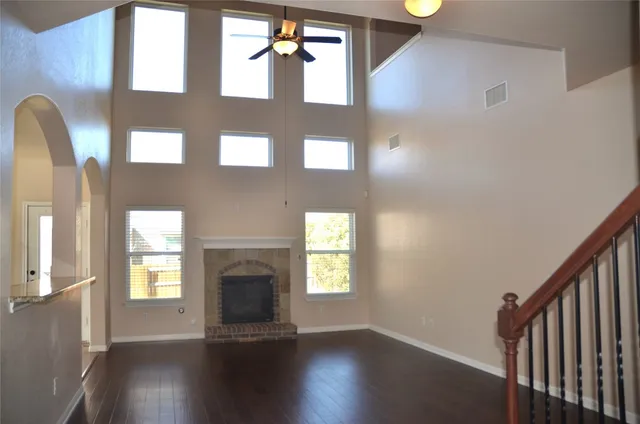 a view of an entryway with wooden floor and a fireplace