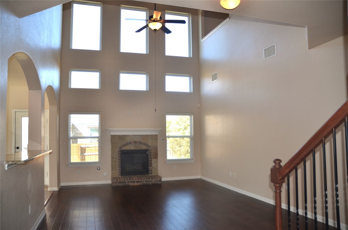 8528 Reggio Street Round Rock, TX 78665 - Photo 7 of 27 a view of an entryway with wooden floor and a fireplace