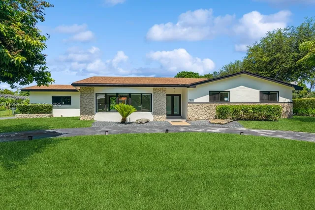 a front view of house with yard and green space