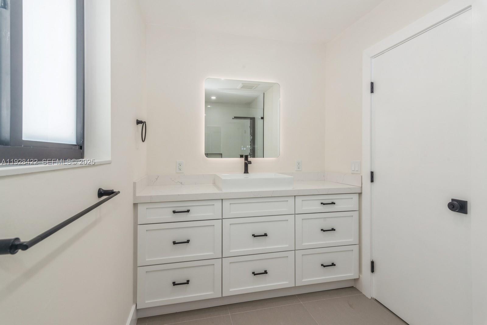 7001 Southwest 126th Street Pinecrest, FL 33156 - Photo 13 of 35 a bathroom with a sink mirror and