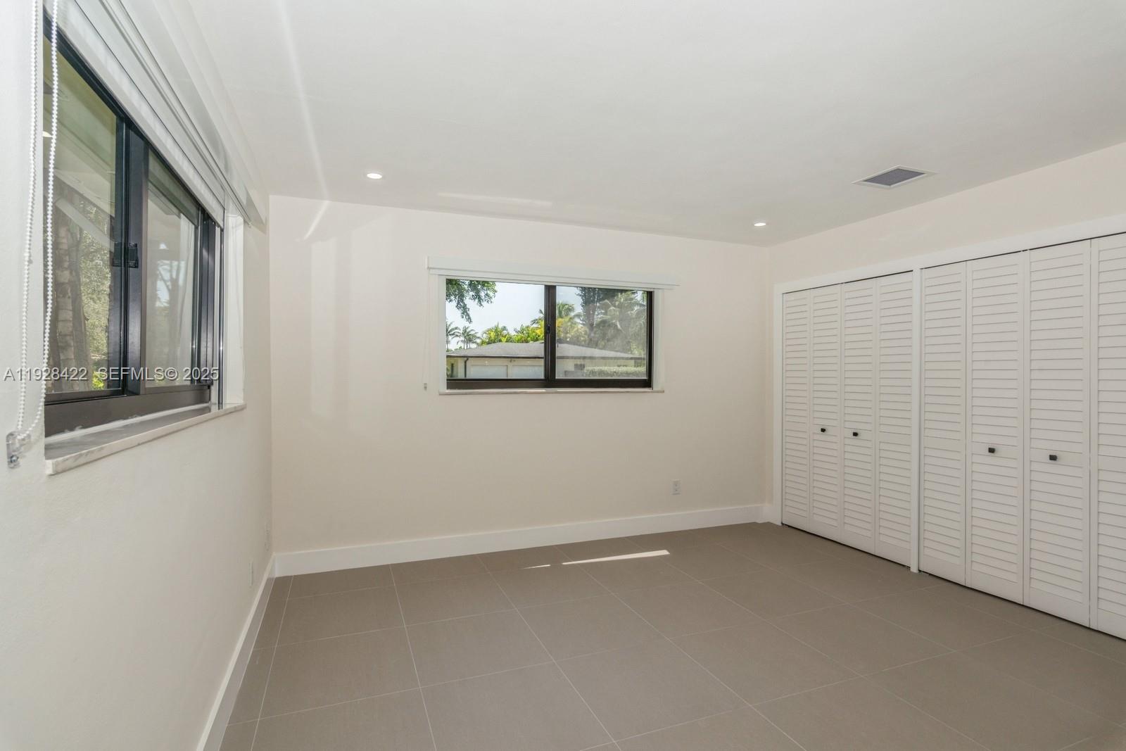 7001 Southwest 126th Street Pinecrest, FL 33156 - Photo 16 of 35 an empty room with a window