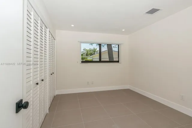 a view of an empty room with windows