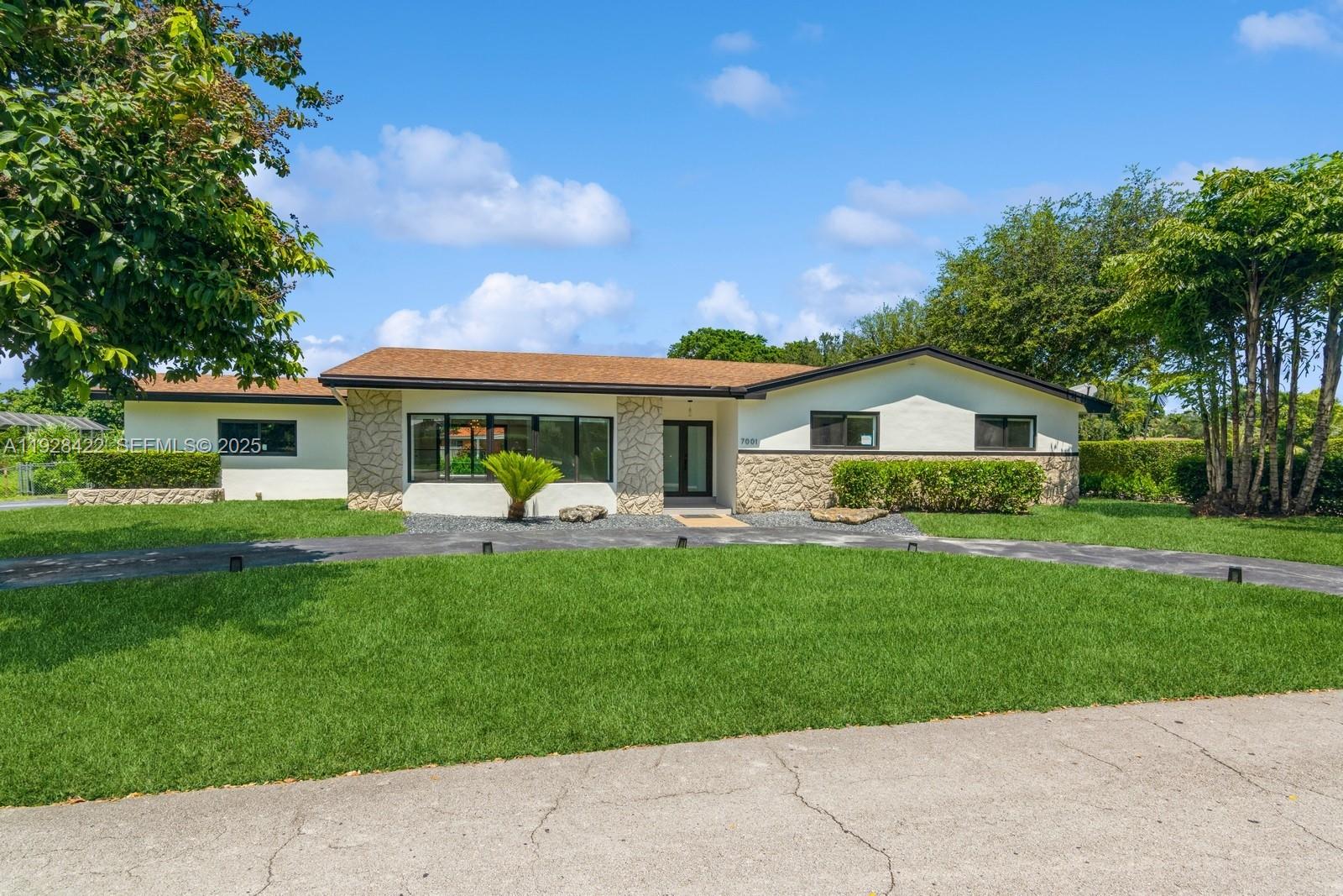 7001 Southwest 126th Street Pinecrest, FL 33156 - Photo 2 of 35 a front view of house with yard and green space