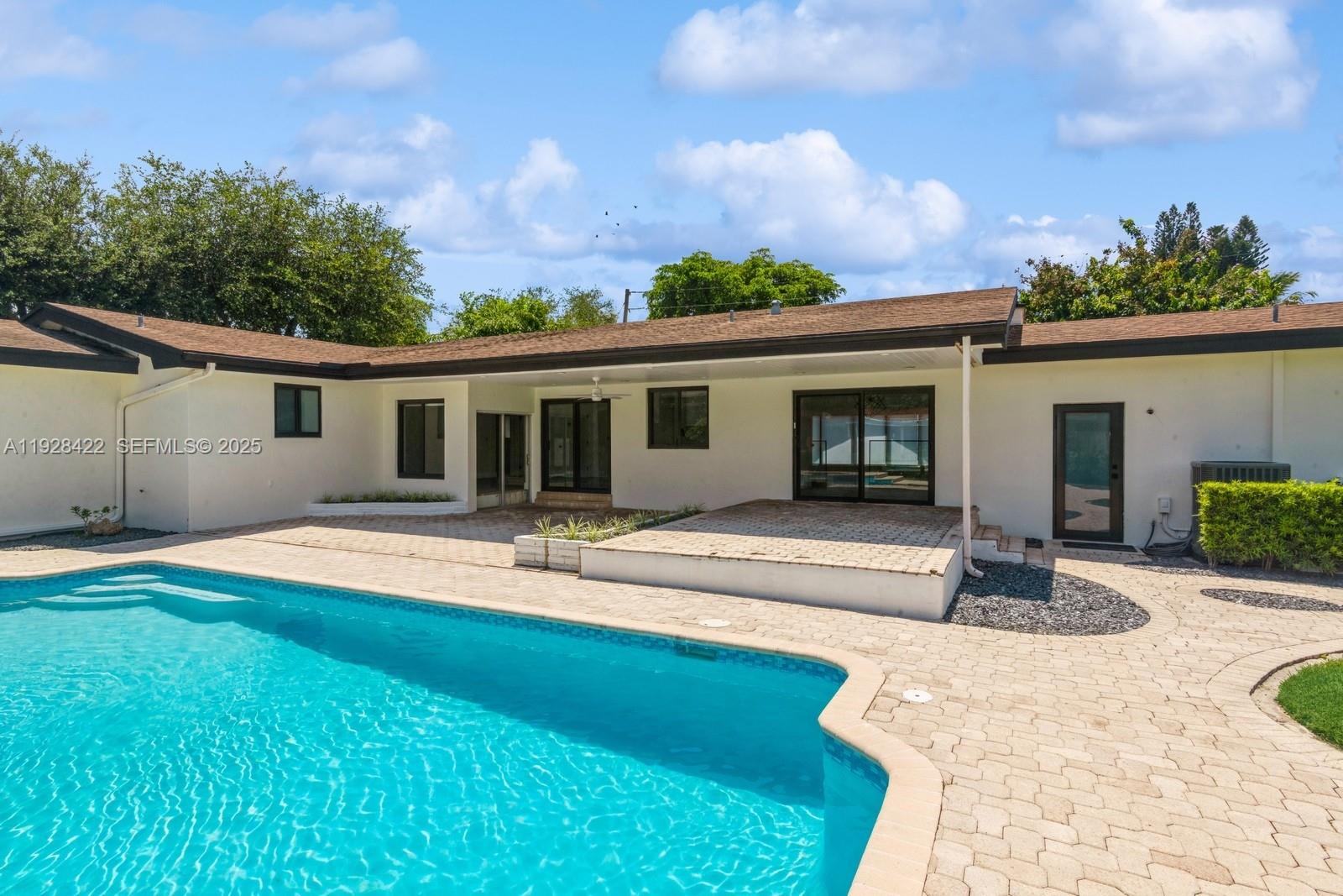 7001 Southwest 126th Street Pinecrest, FL 33156 - Photo 21 of 35 front view of a house with a patio