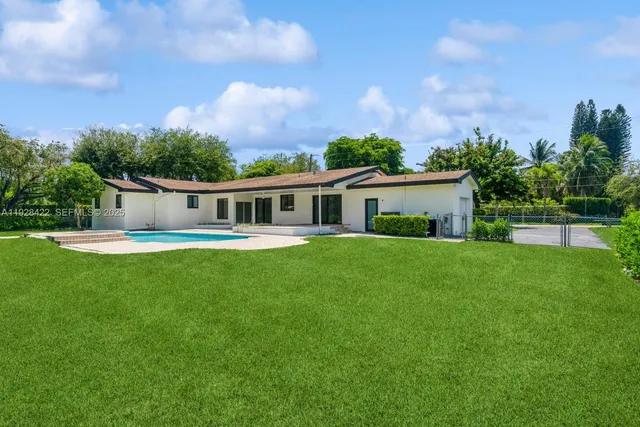 a front view of house with yard and green space