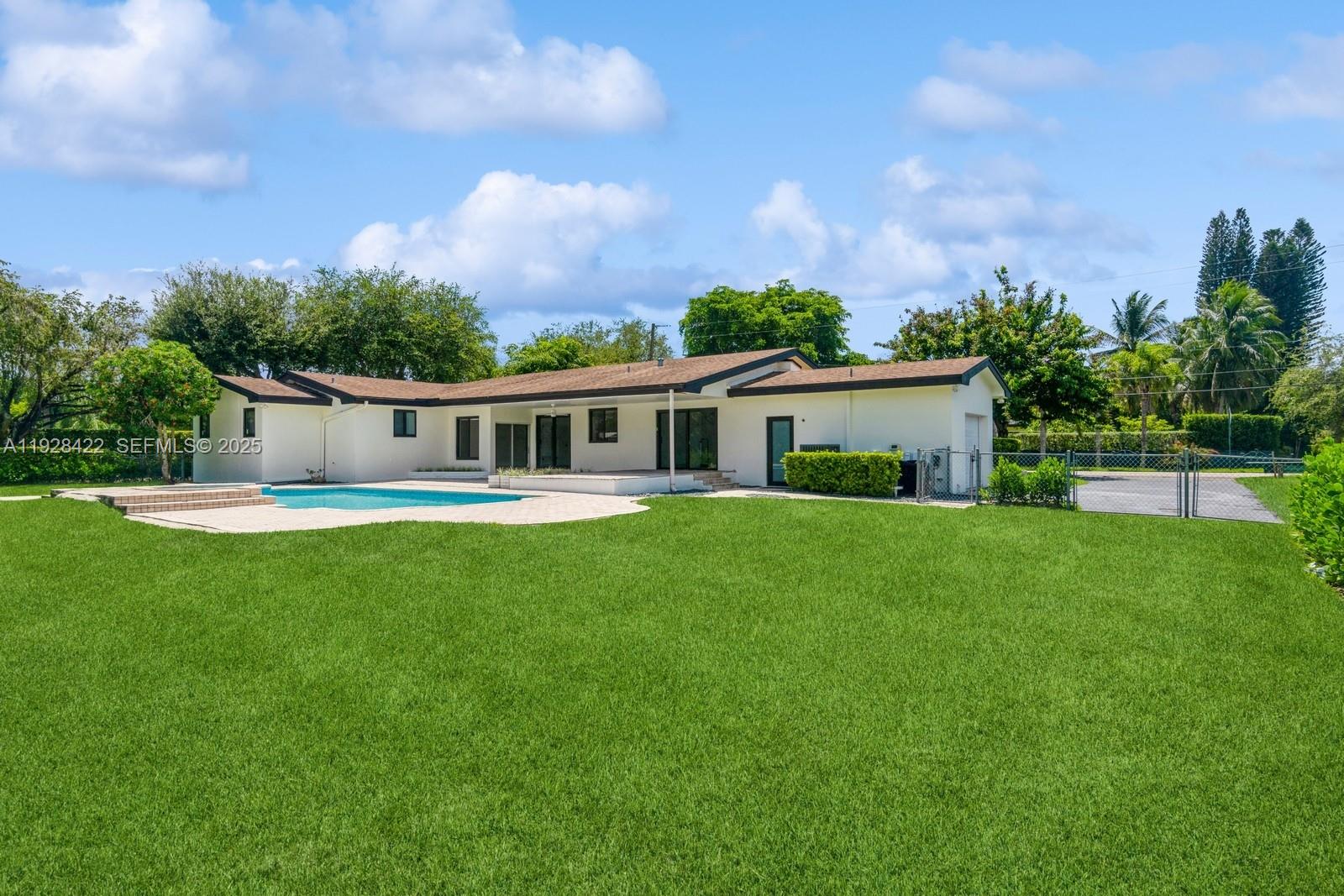 7001 Southwest 126th Street Pinecrest, FL 33156 - Photo 27 of 35 a front view of house with yard and green space
