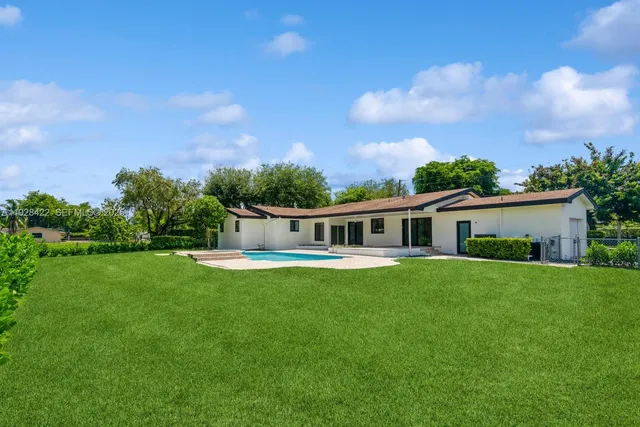 a front view of a house with a yard table and chairs