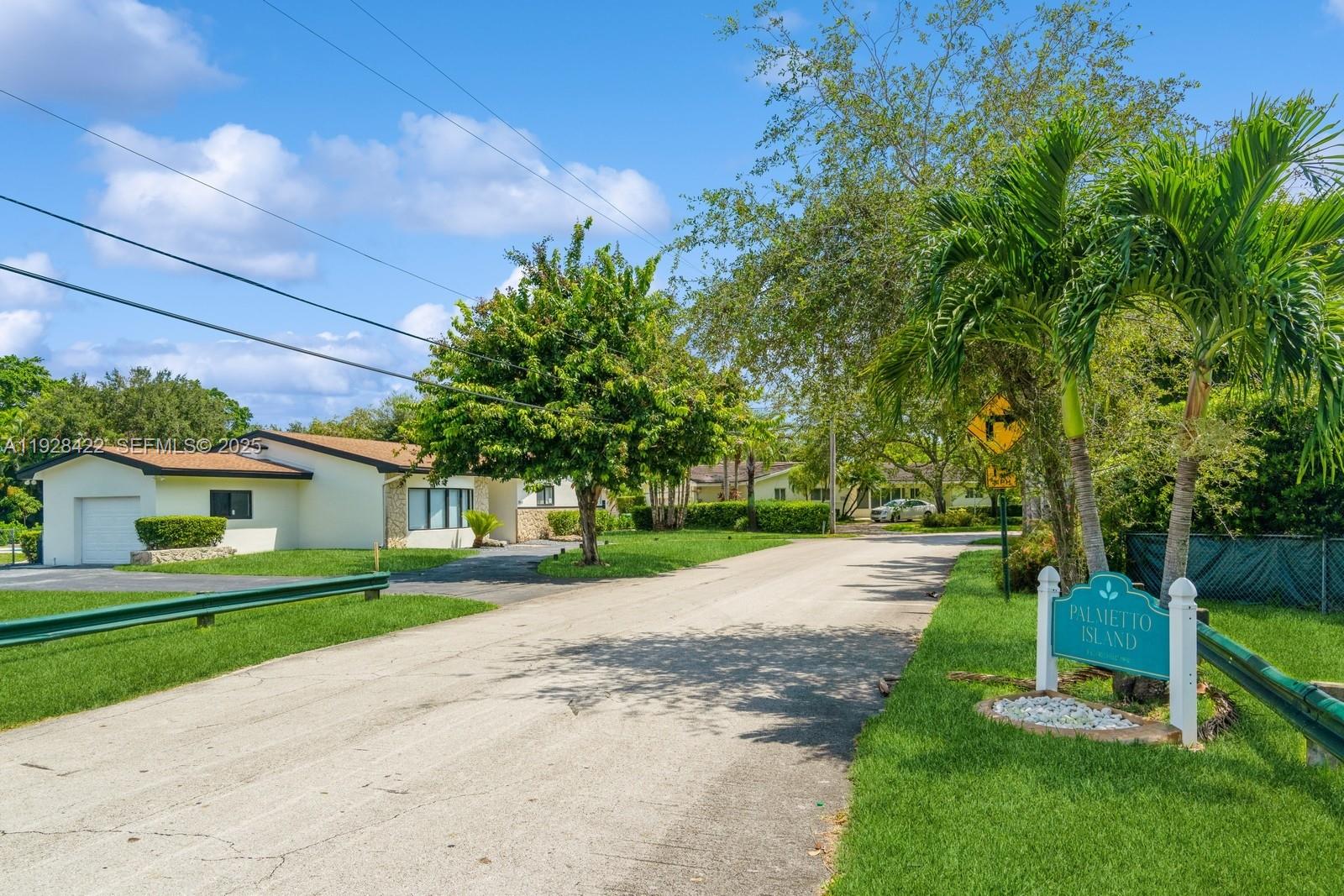 7001 Southwest 126th Street Pinecrest, FL 33156 - Photo 32 of 35 a front view of a house with a yard and trees
