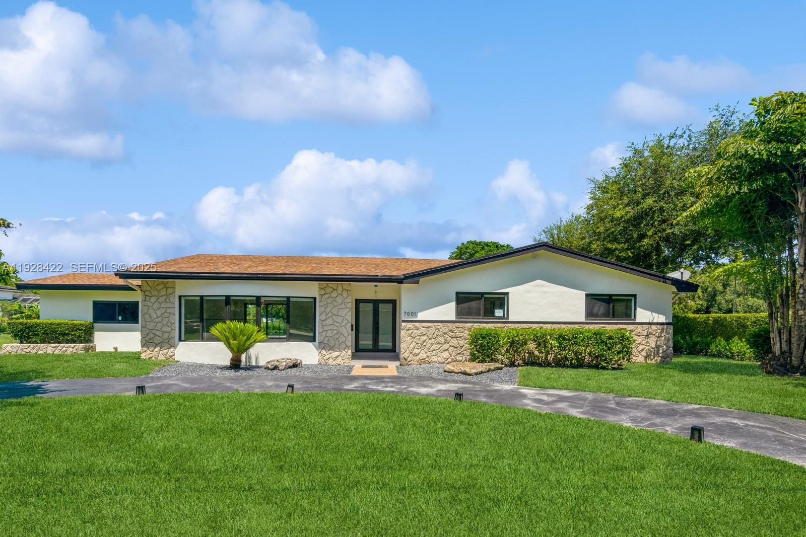 7001 Southwest 126th Street Pinecrest, FL 33156 - Photo 4 of 35 a front view of a house with garden