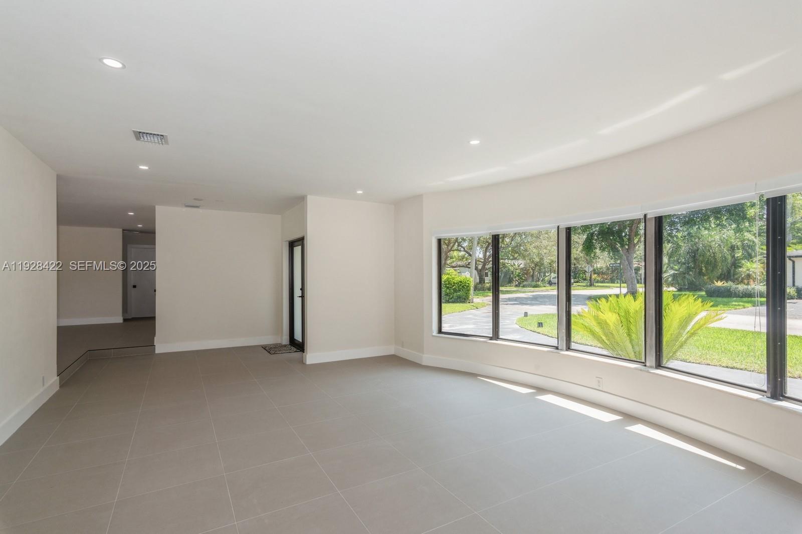7001 Southwest 126th Street Pinecrest, FL 33156 - Photo 5 of 35 a view of an empty room with a window