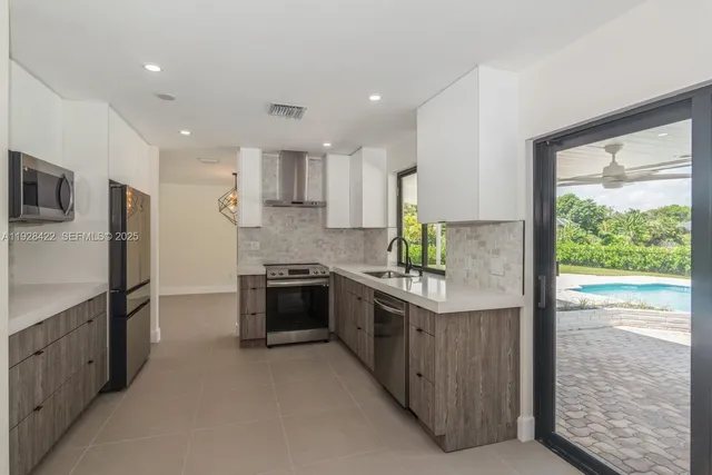 a kitchen with stainless steel appliances granite countertop a stove and a refrigerator
