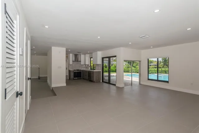 an empty room with furniture and windows