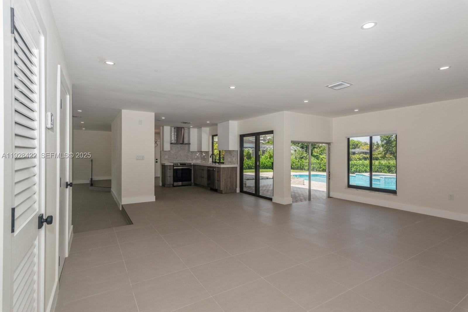 7001 Southwest 126th Street Pinecrest, FL 33156 - Photo 9 of 35 an empty room with furniture and windows
